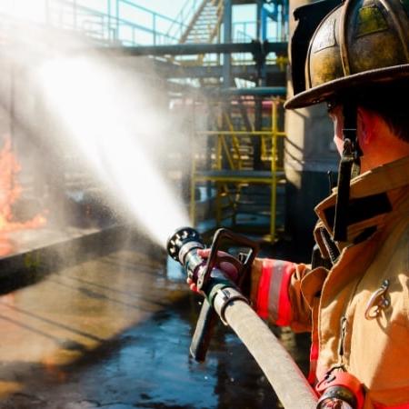 Male fireman putting out a dock fire